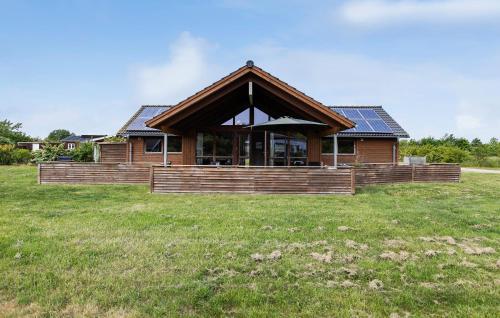a house in a field with a grass field at Pet Friendly Home In Sydals With Sauna in Neder Lysabild