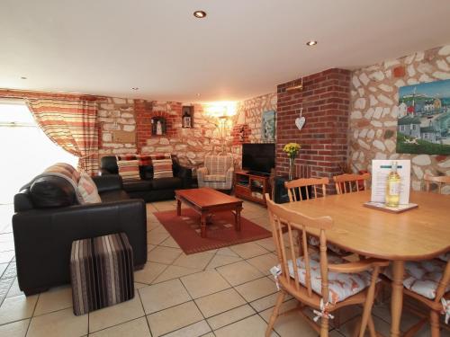 a living room with a couch and a table at Seagull Cottage in Flamborough