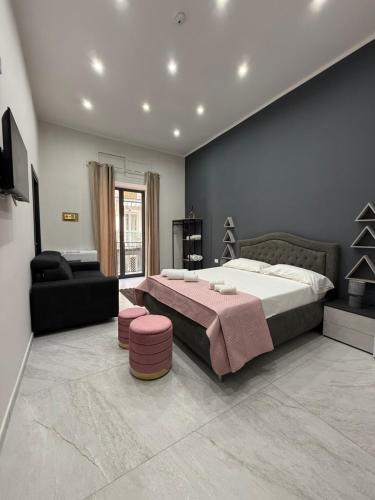 a bedroom with a large bed and a couch at Palazzo Valentino in Naples