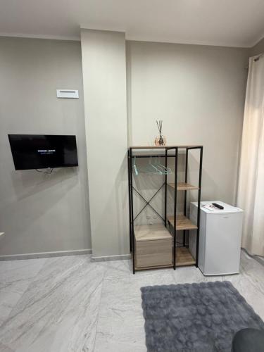 a room with a glass cabinet and a television at Palazzo Valentino in Naples