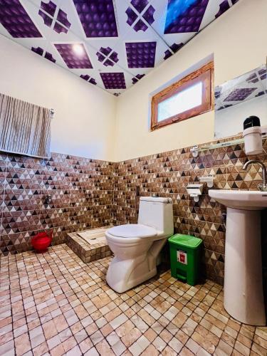 a bathroom with a toilet and a sink at Riverfront resort sooq valley in Dargai