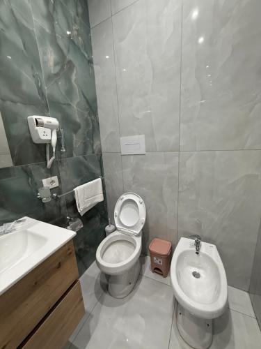 a bathroom with a white toilet and a sink at Palazzo Valentino in Naples