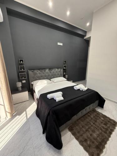 a bedroom with a large bed with towels on it at Palazzo Valentino in Naples