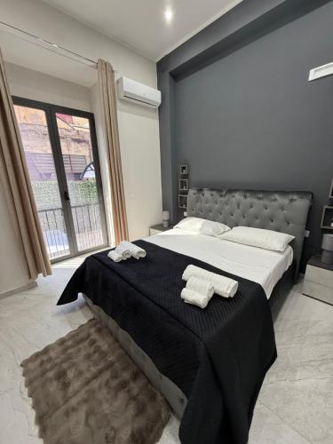 a bedroom with a large bed with two towels on it at Palazzo Valentino in Naples