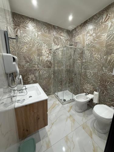 a bathroom with a shower and a toilet and a sink at Palazzo Valentino in Naples