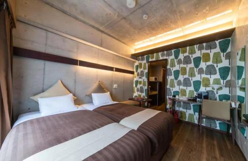 a bedroom with a large bed in a room at Condominio Makishi Annesso in Naha