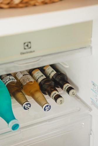 a bunch of wine bottles in a refrigerator at Tatadise in Tatajuba