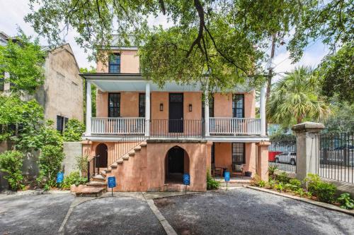 an old house with a balcony and a driveway at Revitalized Historical Southern Residence in Charleston