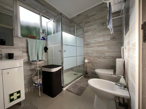 ein Badezimmer mit Dusche, Toilette und Waschbecken in der Unterkunft Green Sunrise House in Nordeste