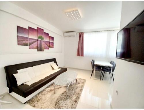 a living room with a couch and a table at Apartment Silvia in Makarska