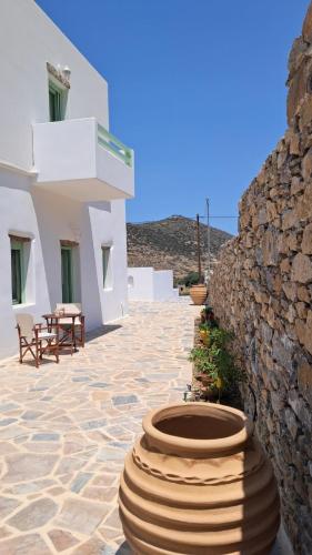 a patio with a building and a stack of tires at Arkesini Apartments in Arkesíni
