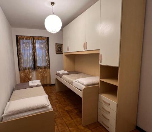 a room with two bunk beds and a window at Al glicine in Lovere