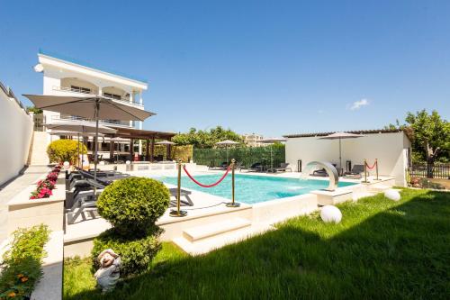 a house with a swimming pool and a yard at Guest House Pasha in Ulcinj