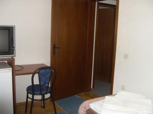a room with a desk and a chair next to a door at Residence Krstanoski in Ohrid