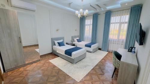 a bedroom with a bed and a couch and a mirror at Turon City Hotel in Samarkand