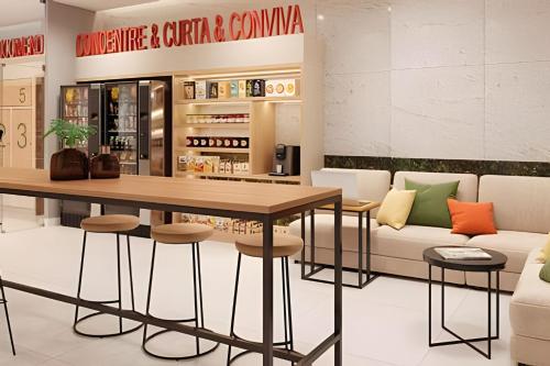 a restaurant with a table and chairs and a couch at Casa Maua in Rio de Janeiro