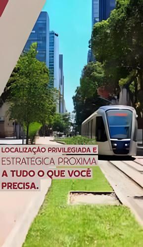 a train is on the tracks in a city at Casa Maua in Rio de Janeiro