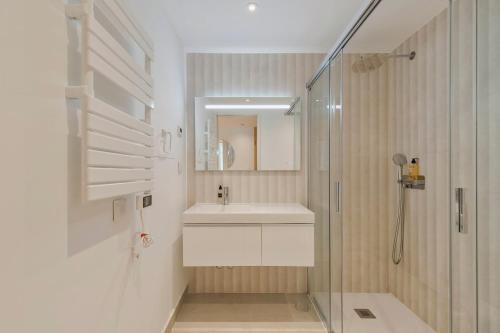 a bathroom with a sink and a shower at Setúbal Luxury Apartment in Setúbal