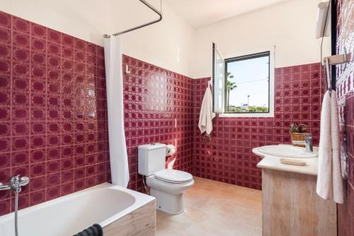 a bathroom with a red tiled wall at New! Villa Margarita - Menorca in Punta Prima