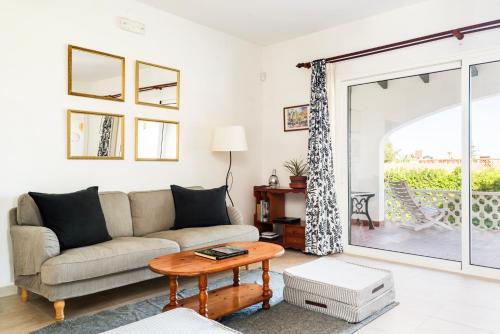 a living room with a couch and a table at New! Villa Margarita - Menorca in Punta Prima