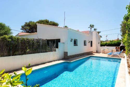 a villa with a swimming pool in front of a house at New! Villa Margarita - Menorca in Punta Prima