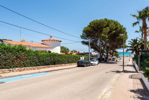 a street with cars parked on the side of the road at New! Villa Margarita - Menorca in Punta Prima