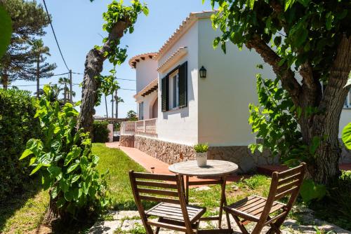 a table and chairs in front of a house at New! Villa Margarita - Menorca in Punta Prima