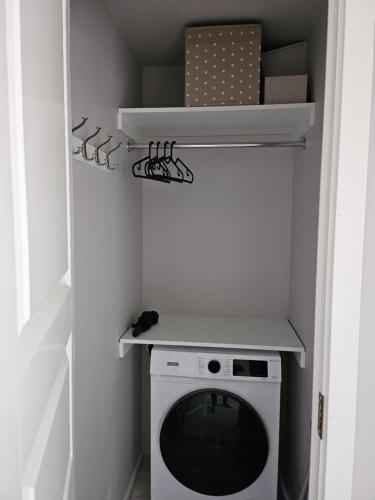 a small laundry room with a washer and dryer at Side Apartments in Rakvere