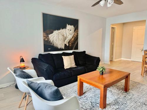 a living room with a black couch and a table at Heart Downtown 2BD NEW Paint floor CITY View LM207 in Atlanta