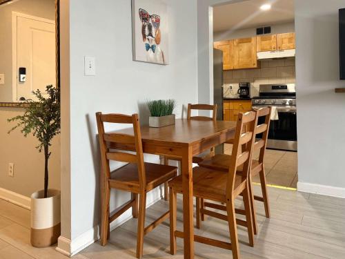 a kitchen and dining room with a wooden table and chairs at Heart Downtown 2BD NEW Paint floor CITY View LM207 in Atlanta