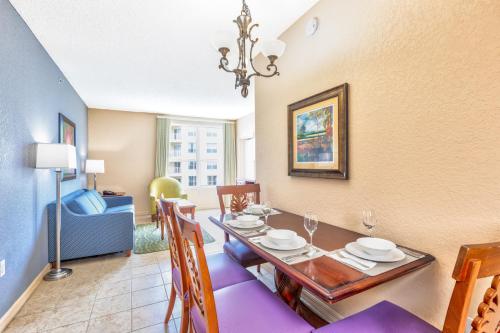 a dining room with a table and chairs and a room at Vacation Village at Parkway in Orlando