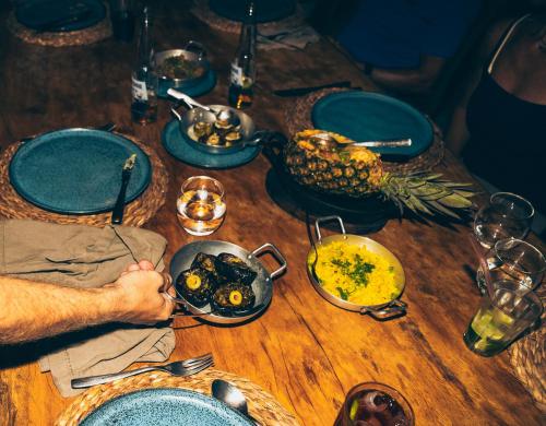 a wooden table with dishes of food on it at Tatadise in Tatajuba