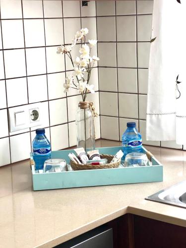 a tray with flowers and blue bottles on a kitchen counter at Villa Aire in Cala en Blanes