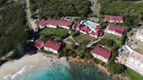 an aerial view of a house next to the ocean at Villa by the sea in Five Islands Village