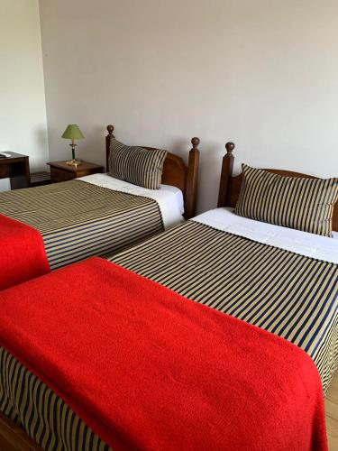 two beds sitting next to each other in a room at Casa Augusta - QUINTA in Penafiel