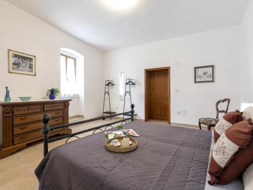 a bedroom with a bed with a basket on a table at Apartment Sos Candhaleris by Interhome in Nulvi