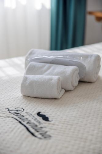 three towels sitting on top of a bed at Agriturismo Bonaventura in Montefiascone