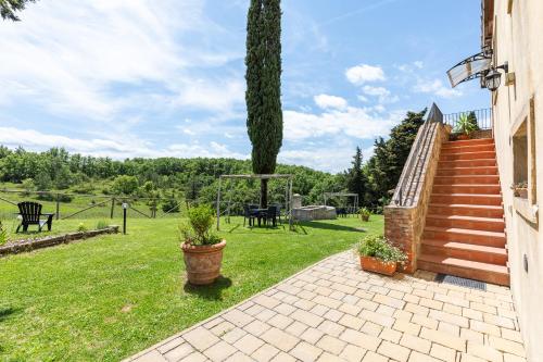 a garden with a gazebo and a tree at Masseria del bosco Poderuccio in Chianciano Terme