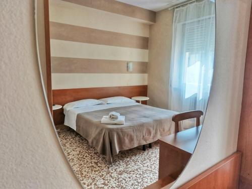 a bedroom with a bed and a mirror at Hotel Residence Sant'Anna in Bedonia