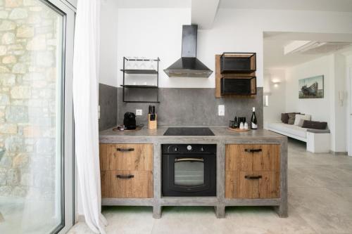 a kitchen with a sink and a stove at Elements Villas in Lardos