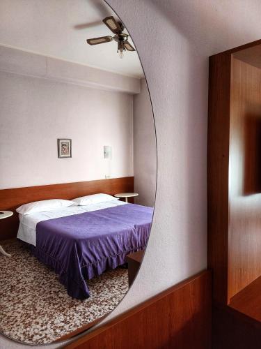 a bedroom with a bed and a mirror at Hotel Residence Sant'Anna in Bedonia