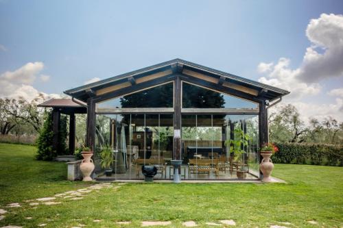 a pavilion with tables and chairs in a yard at Agriturismo Bonaventura in Montefiascone