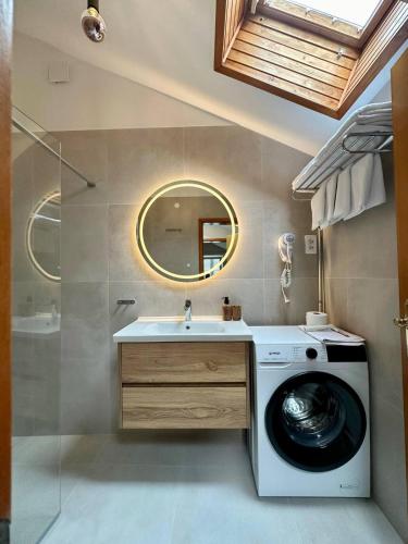 a bathroom with a washing machine and a sink at Apartments Kalina in Jelsa