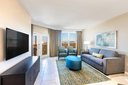 a living room with a couch and a flat screen tv at Vacation Village at Parkway in Orlando