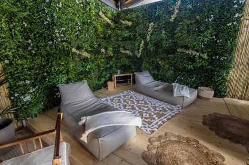 a patio with a green wall with a couch at Agriturismo Bonaventura in Montefiascone
