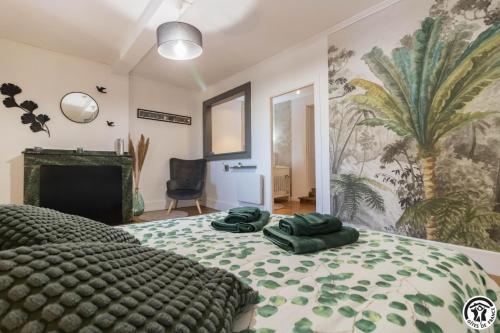 a bedroom with a bed with two green towels on it at Le gîte du besson in Cassagne