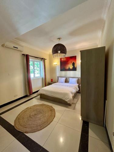 a bedroom with a bed and a rug on the floor at Sea view Ginger apartment in Pointe aux Biches