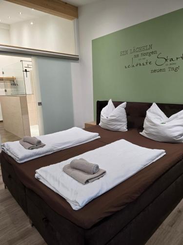 two beds in a room with towels on them at Eiselehof Ferienwohnungen in Alleinlage in Rot am See