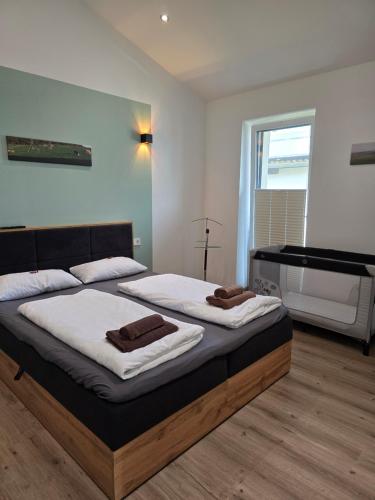 a bedroom with two beds and a piano at Eiselehof Ferienwohnungen in Alleinlage in Rot am See