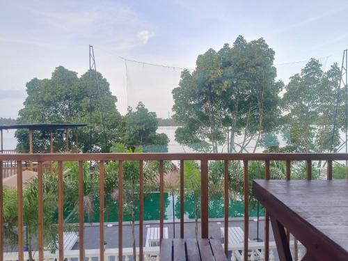 a balcony with a view of a river and trees at Lake view Resort cherai in Cherai Beach